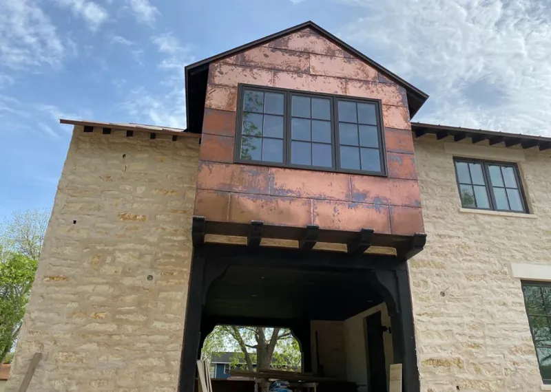 Copper metal panel facade on a stone building for Skylight Installation in Marengo